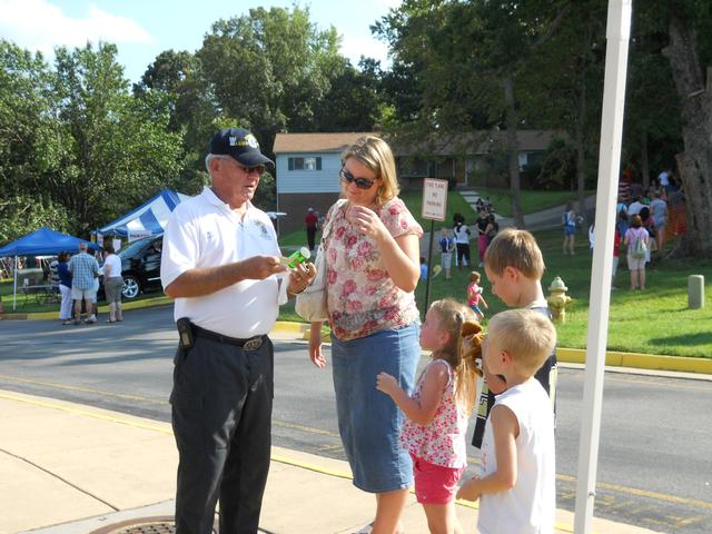 Mike Schaefer talks about child safety seat to family at fall festival. 
9/11/11